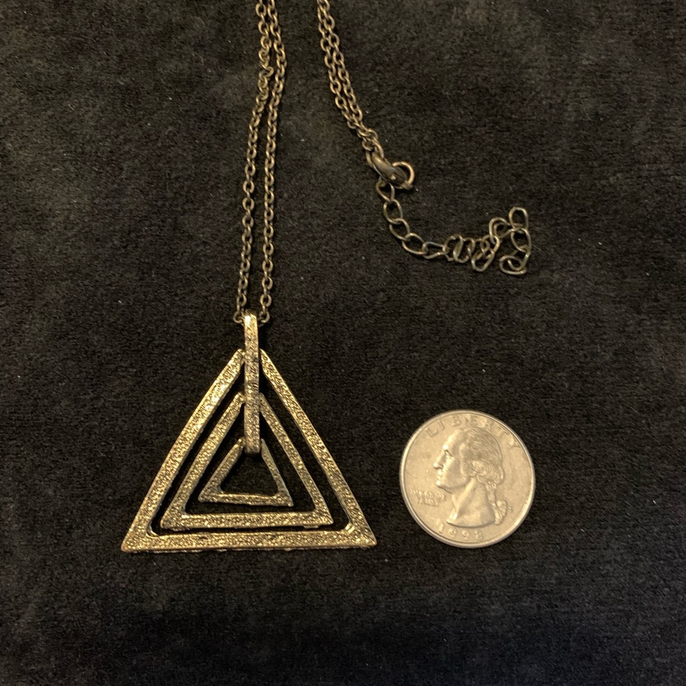 Antique gold (color) floating triangle necklace. Great Minimalist look.